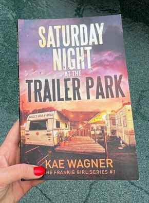 Saturday Night at the Trailer Park. Book with red nails.CU