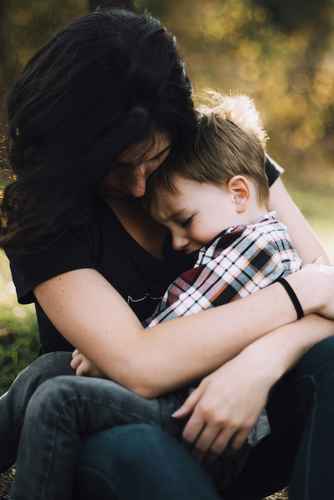 mom hugging son in grief