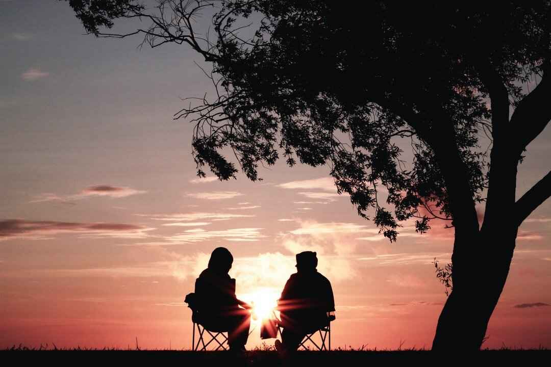 two friends talking at sunset