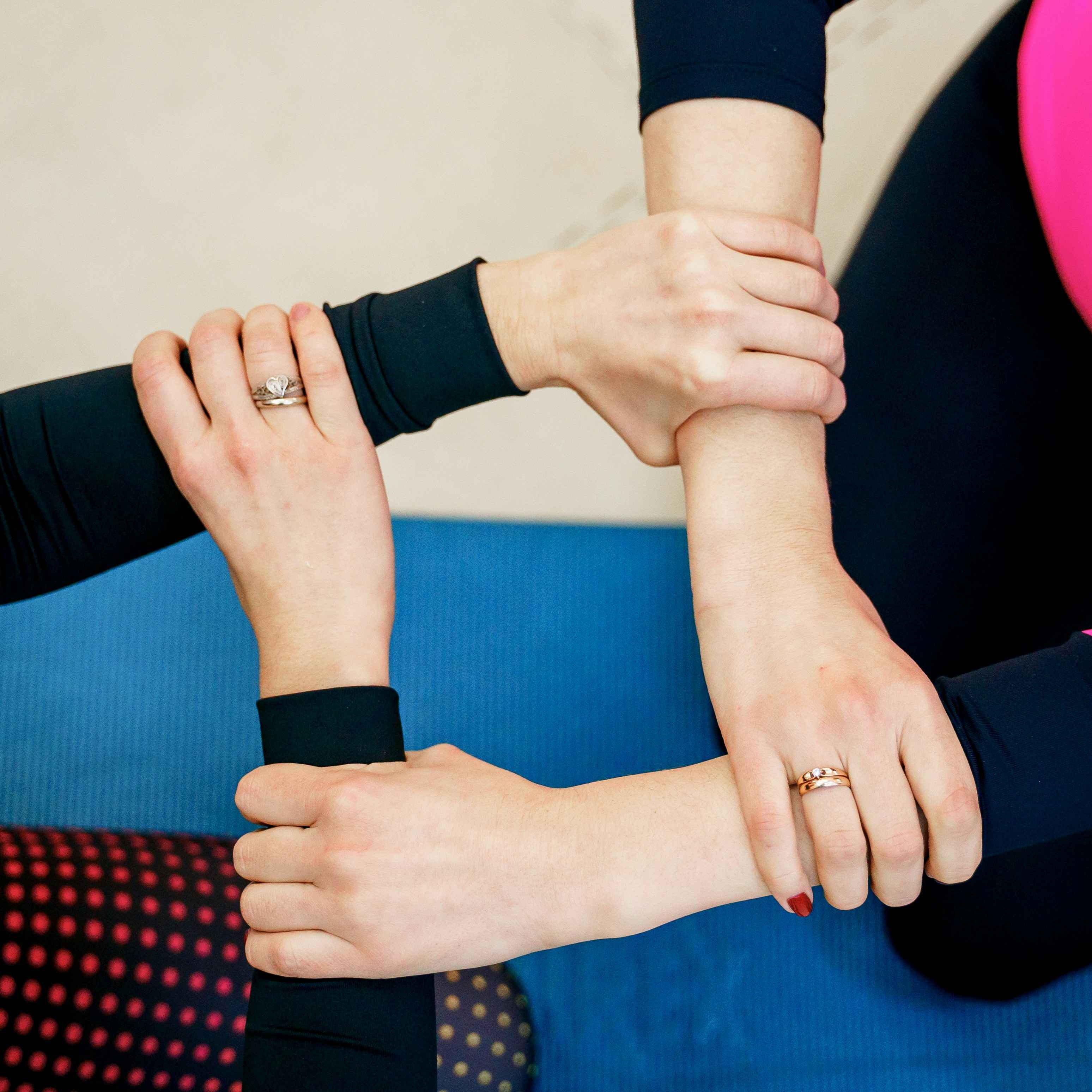 Work colleagues link arms before an event