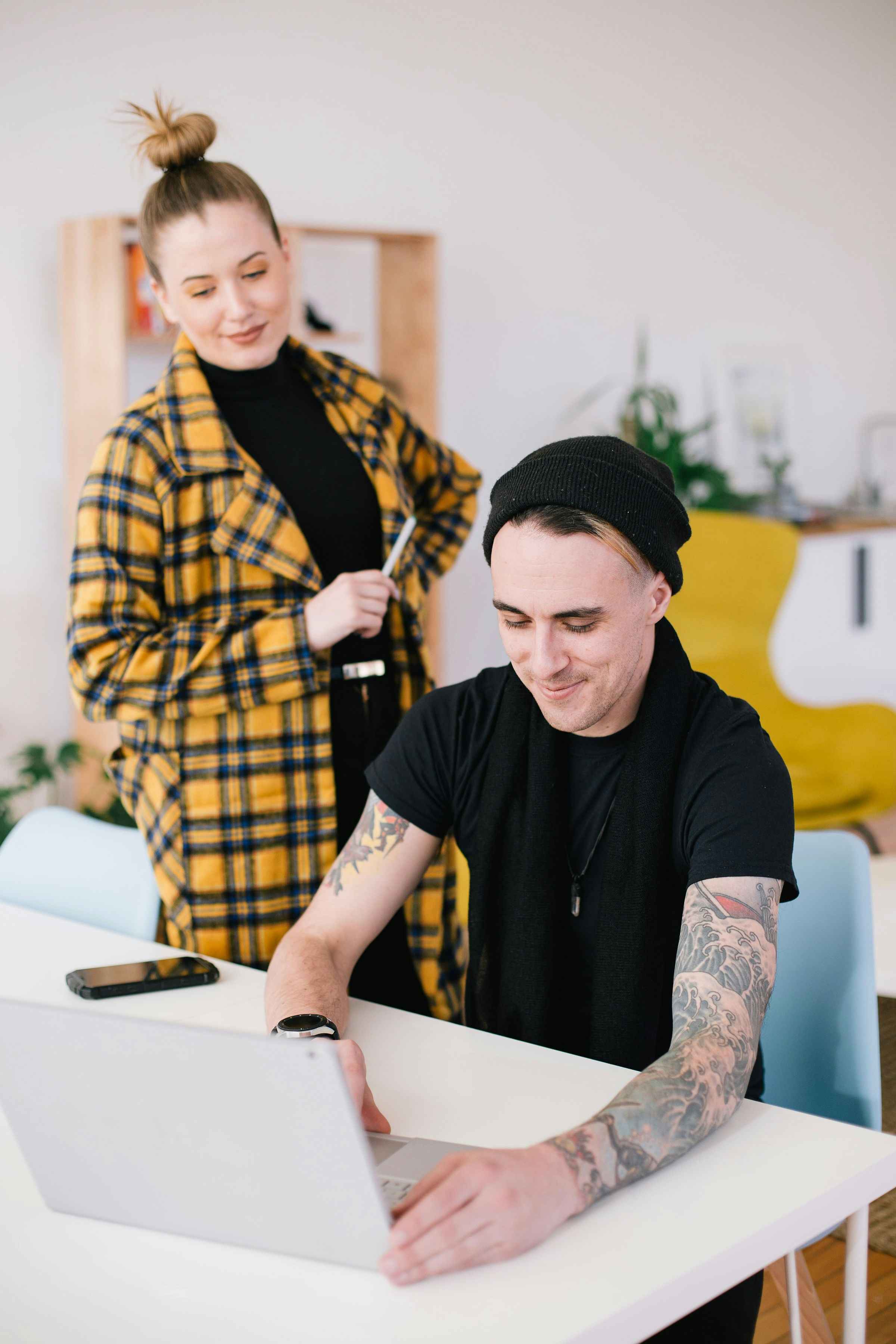 Boss and manager smile while reviewing a report together