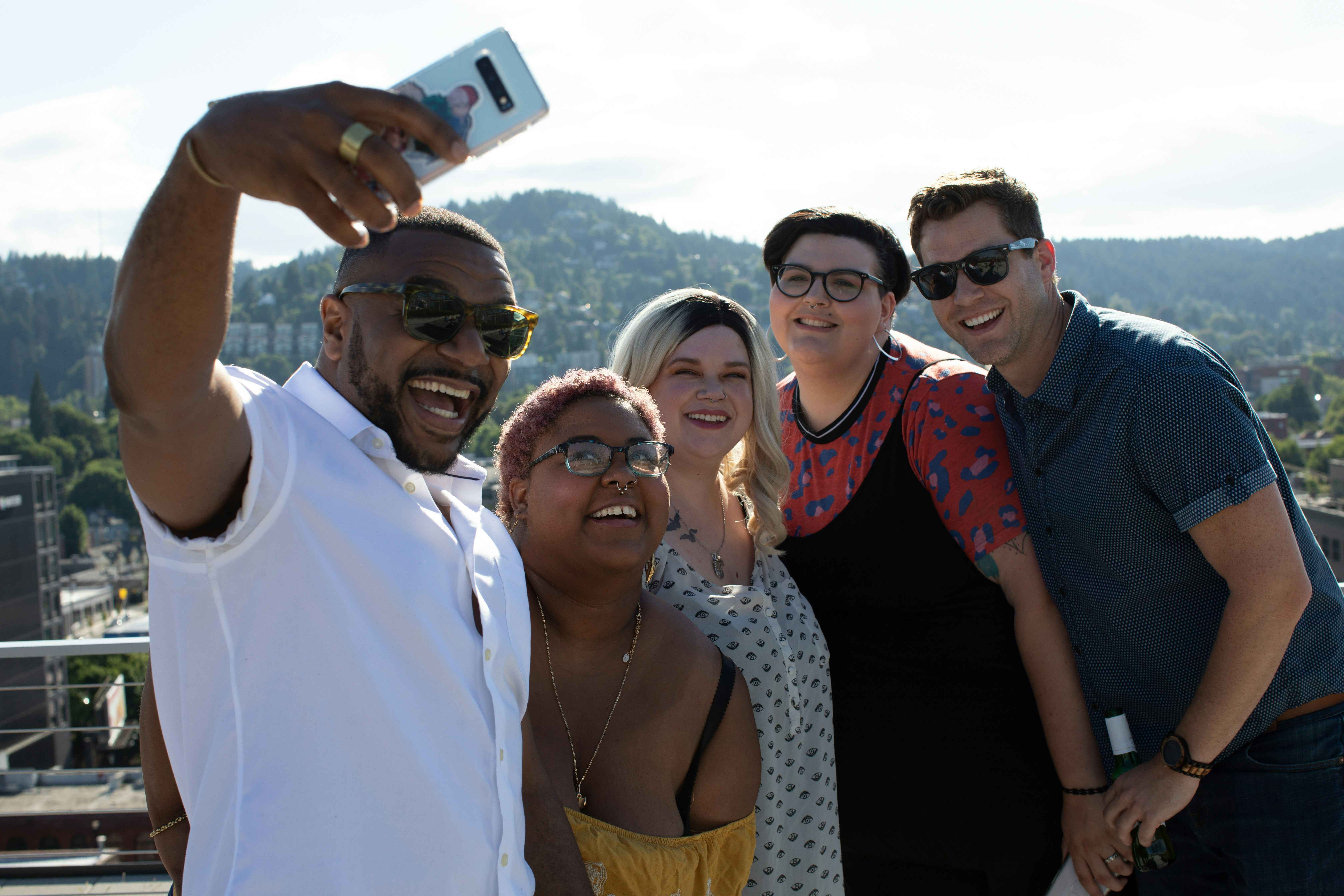 Group of happy professionals posing for a group selfie