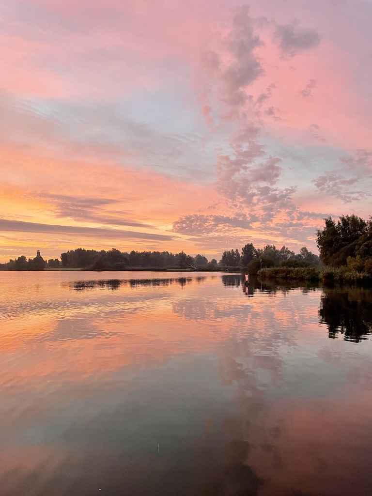 Orange clouds reflected in a lake, sunrise, freedom