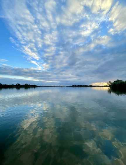 Clouds reflected in the water at sunrise