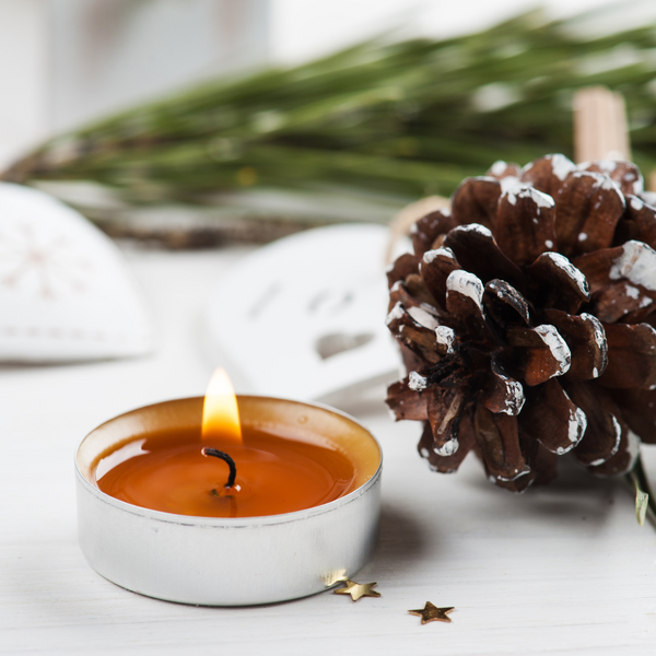 grief during holidays with candle and pine cone