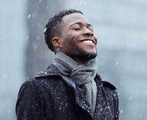 Happy man in snowfall