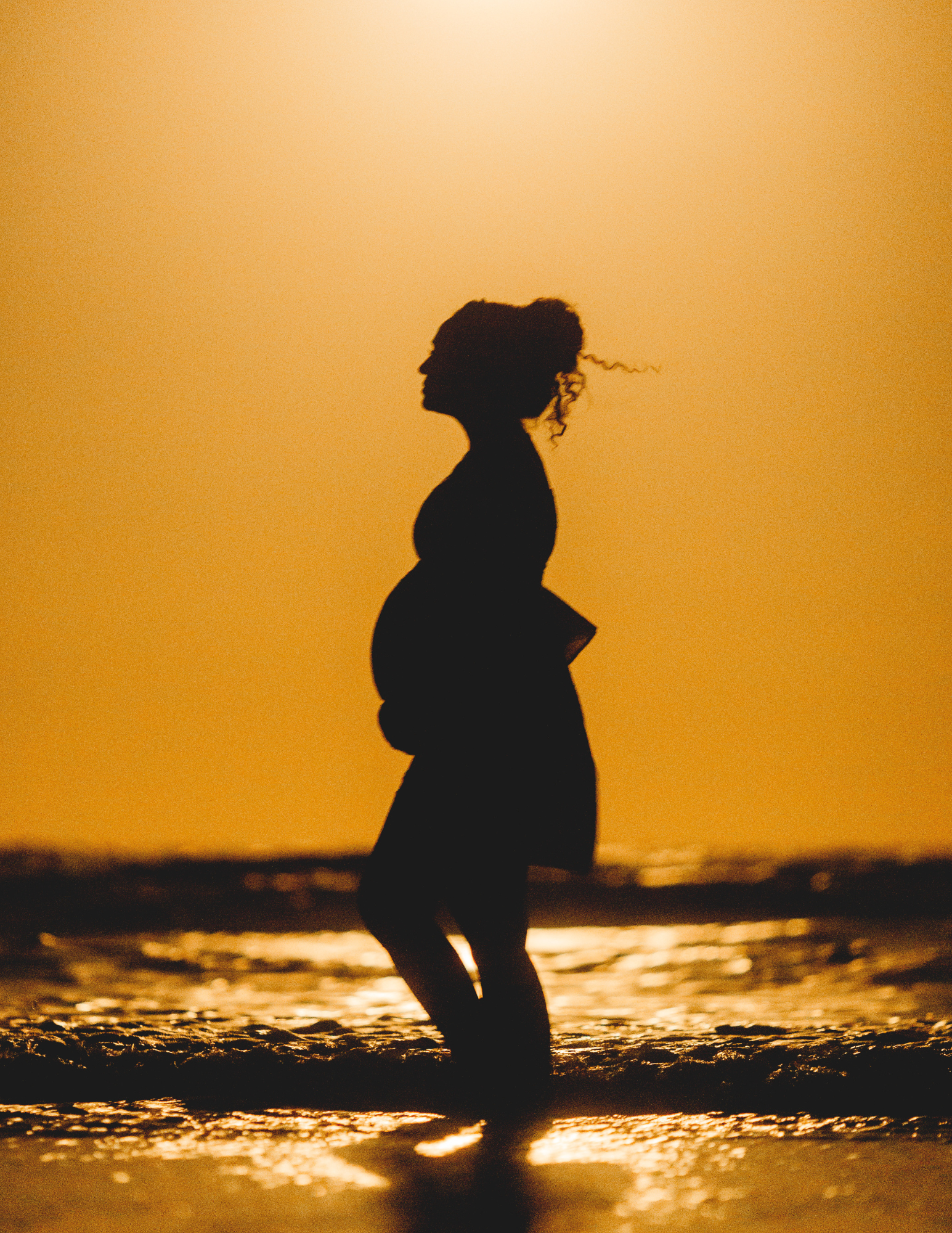 preg woman on beach