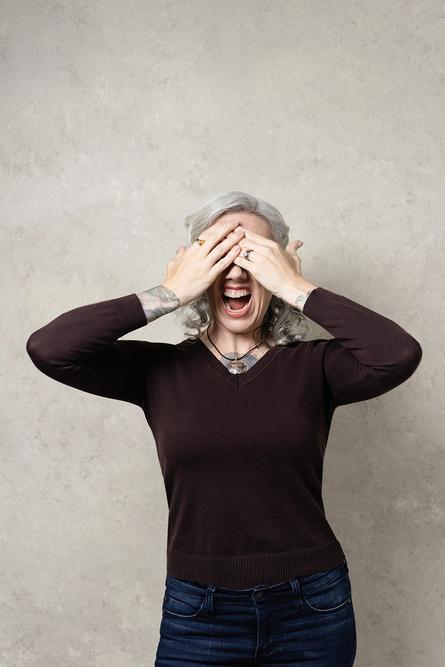 Blaze stands screaming with her hands over her eyes, a moment of stress and overwhelm, remembering her past.