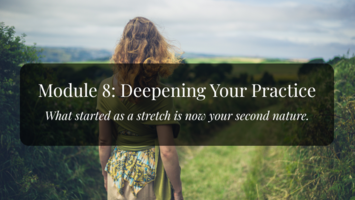 A woman stands looking out over a green field that stretches into the distance. Soft, natural light.