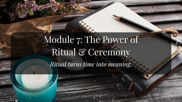 An open journal with a pencil sits atop a leatherbound book. Beside it is a lit candle in a turquoise holder and a potted lavender plant in a copper container.