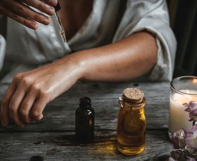 woman using essential oil as part of sustainable resort wellness services