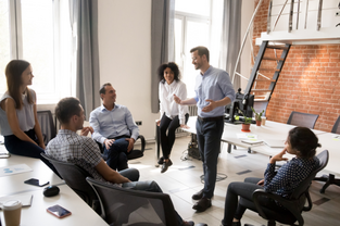 image of a team speaking clearly to each other around an office demonstrating emotionally intelligent leadership
