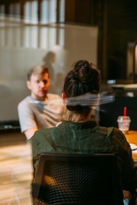 blurred image of a coaching and leadership development professional having a discussion with a manager