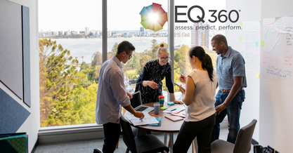 team discussing self-awareness for leaders around a table with 4 chairs