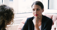 Zoomed in image of a woman executive listening intently to a executive leadership coach