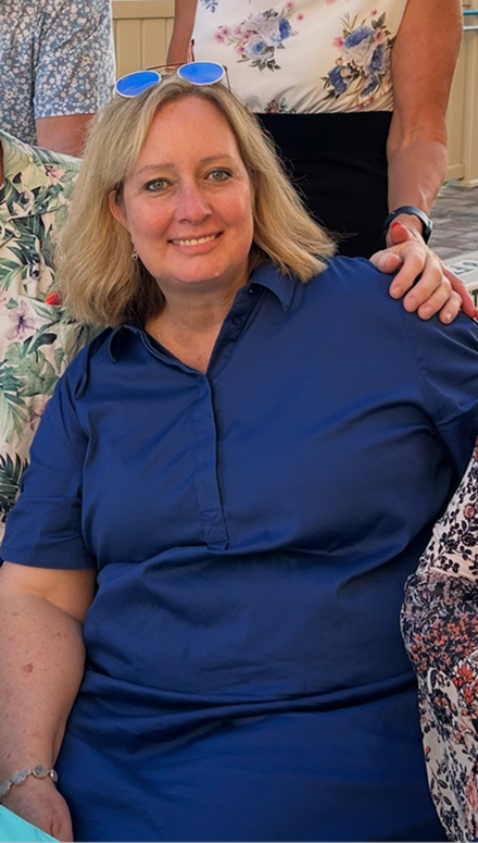 A woman standing next to a beach, doing stretches