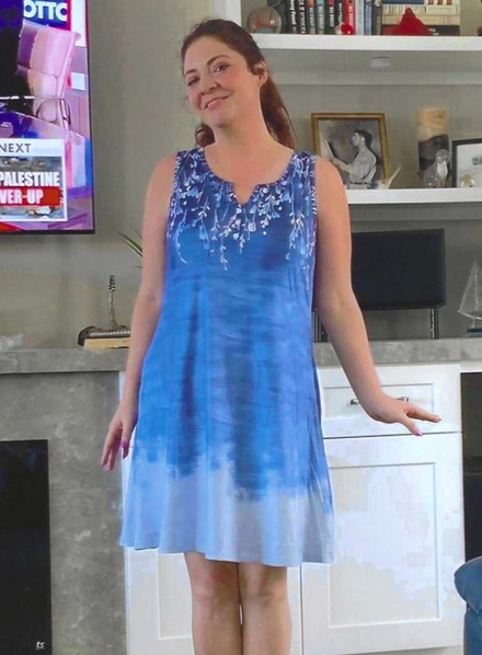 A woman standing next to a beach, doing stretches