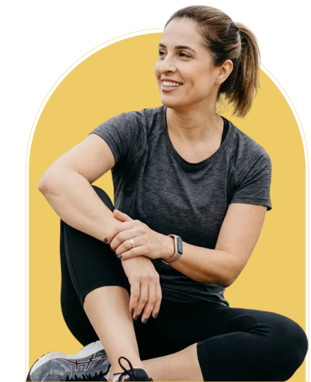 a woman sitting cross-legged in front of a glowing yellow backdrop