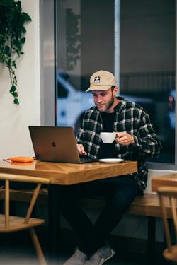 Photo by brooke cagle man-in-black-and-white-plaid-dress-shirt-sitting-by-the-table-using-macbook-Unsplash