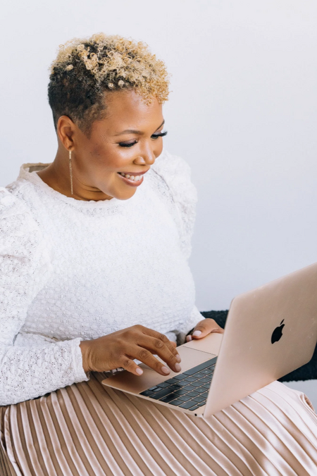 An individual follows along with online meditation courses on their computer.