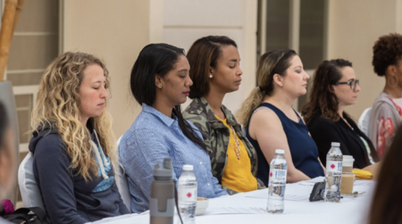 Several conference attendees practice The REST Technique sitting comfortably in chairs
