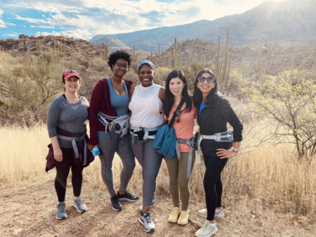 A group of retreat attendees pose for a photo after a group hike.