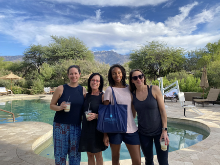 Three retreat attendees and Dr. Jill Wener pose for a photo by the pool at Miraval Spa.