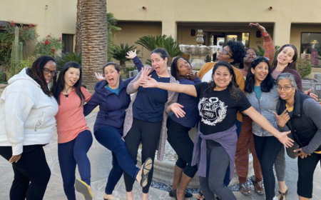 A group of healthcare professionals pose for a silly photo during the Women in Healthcare Meditation Retreat.