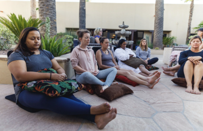 Learn to Meditate Comfortably and Easily / Retreat attendees sit comfortably on the floor, meditating in a peaceful area at the Miraval Spa.