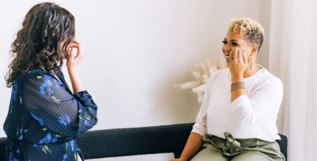 Dr. Jill Wener and a tapping client tap together, facing each other sitting on a bench