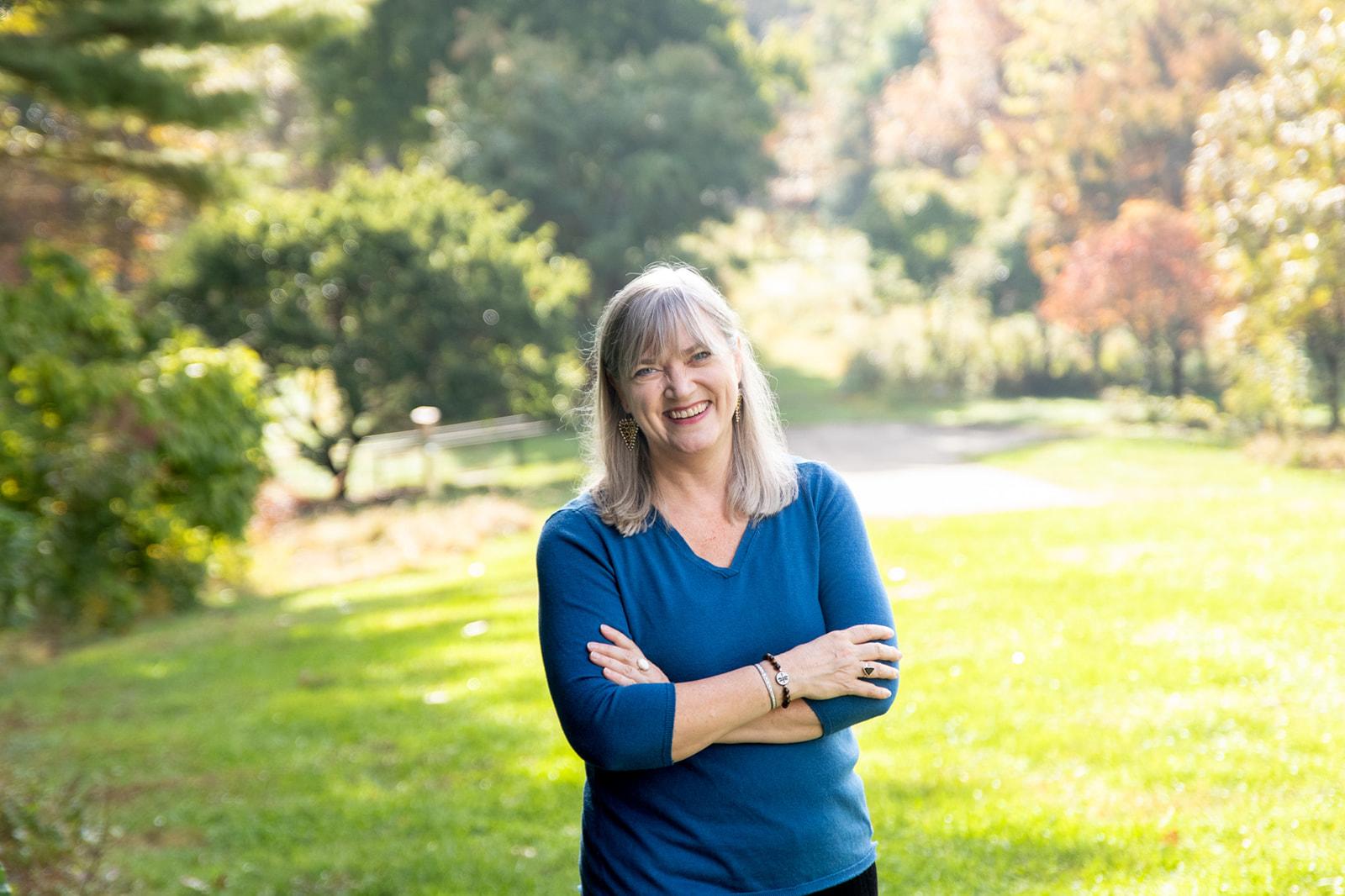 blue sweater arms crossed relaxed