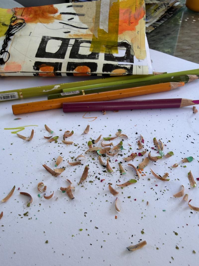 colorful pencil shavings in front of journal