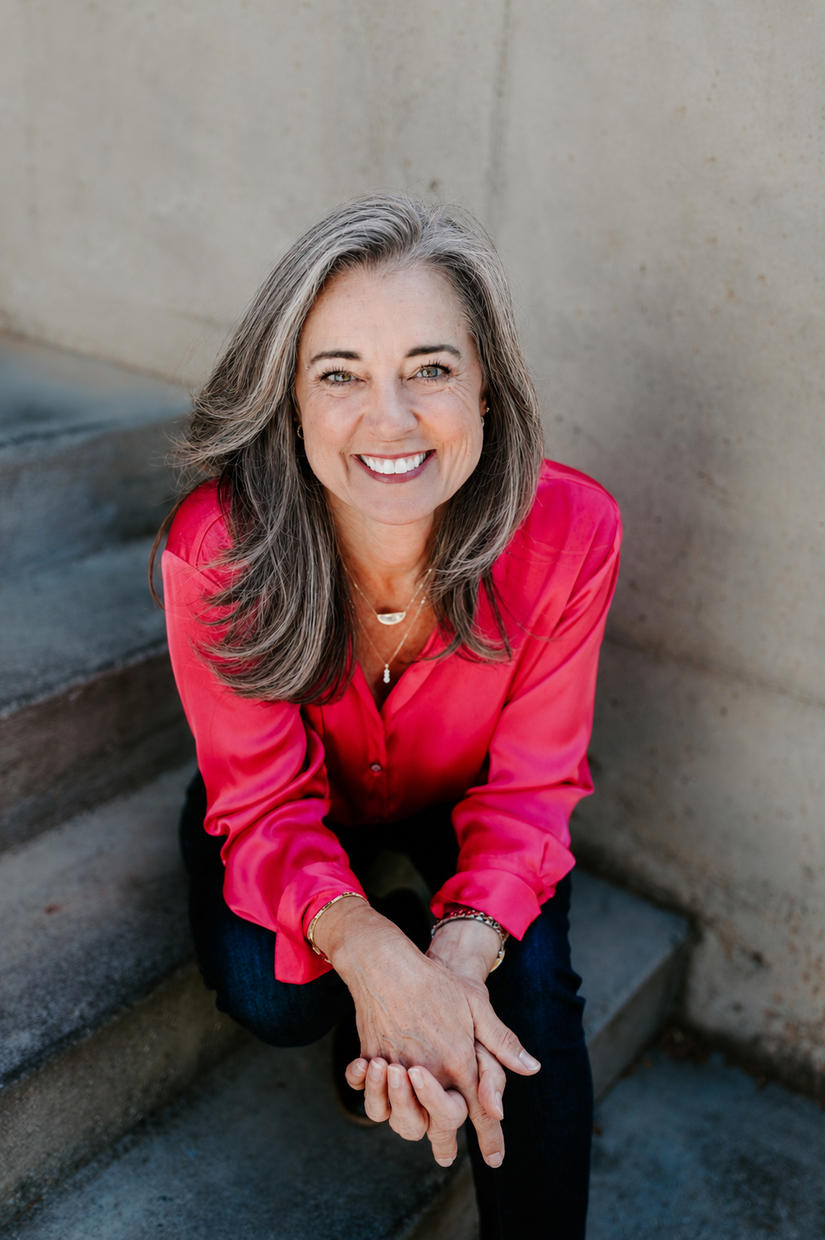 2026_susan in pink shirt sitting on concrete stairs zoomin