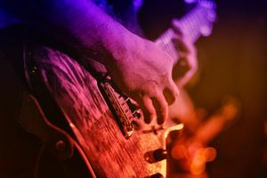 A person playing an electric guitar