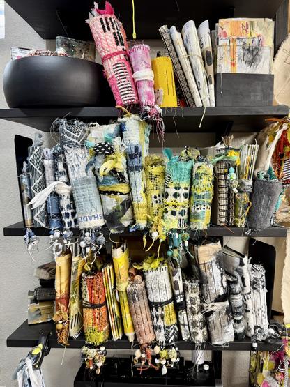 handmade art journals full of texture lined up on book shelves