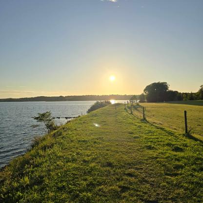 Beautyful picture of a sunset showing land following the seaside