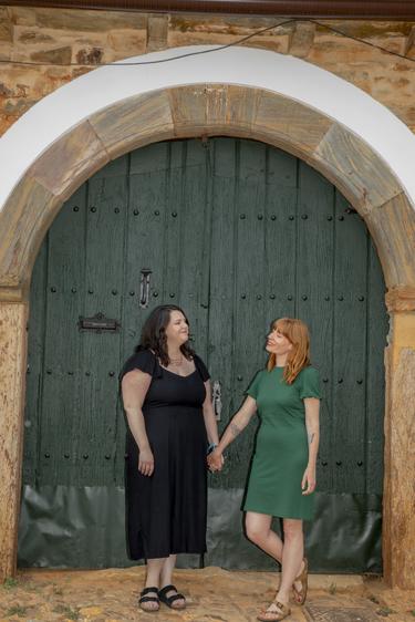 Two participants hold hands and smile at each other as they look into each other's eyes
