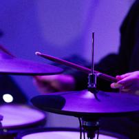 A close up of a drummer at a drum kit