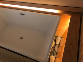 The bed of river rocks beneath the tub