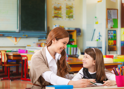 A teacher and student looking at each other and smiling