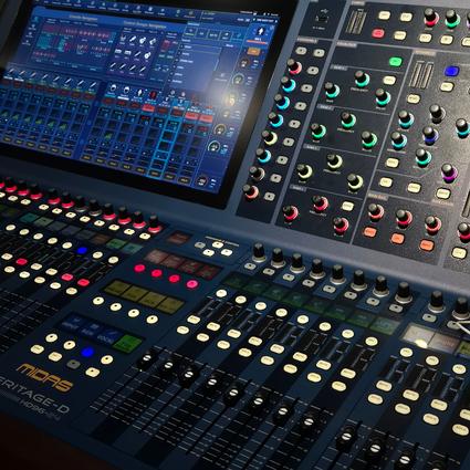 The screen and dials and sliders of a complex sound board