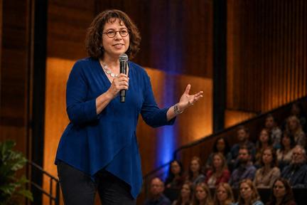 Emma Churchman on stage in a blue shirt