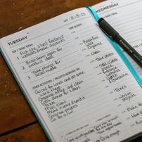 A planner with various tasks listed, showing the day Tuesday