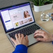 A person designing a website on a MacBook