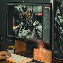 A monitor with photo editing software editing a photo of a person in Halo-esque armor