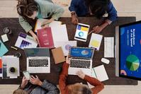 Four people working on a marketing project on a table