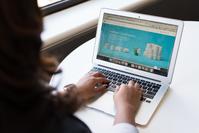 A woman typing on a laptop with a website -builder graphic