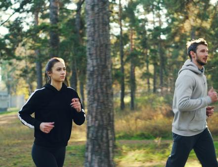 A couple jogging together in a park