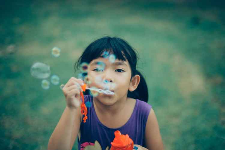 girl-blowing-bubbles-900x600