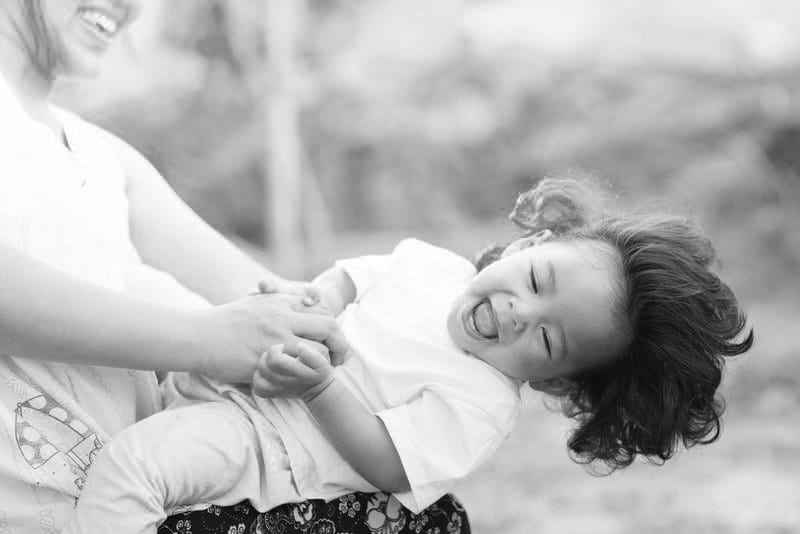 woman-holding-smiling-baby-bw
